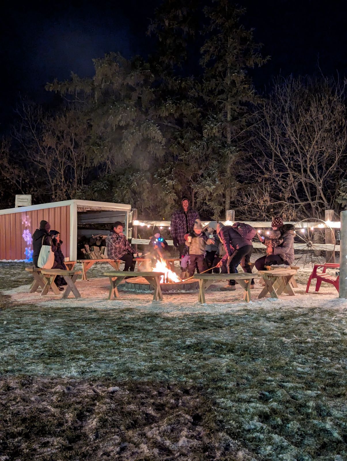 Guests gathered around the bonfire on a winter night