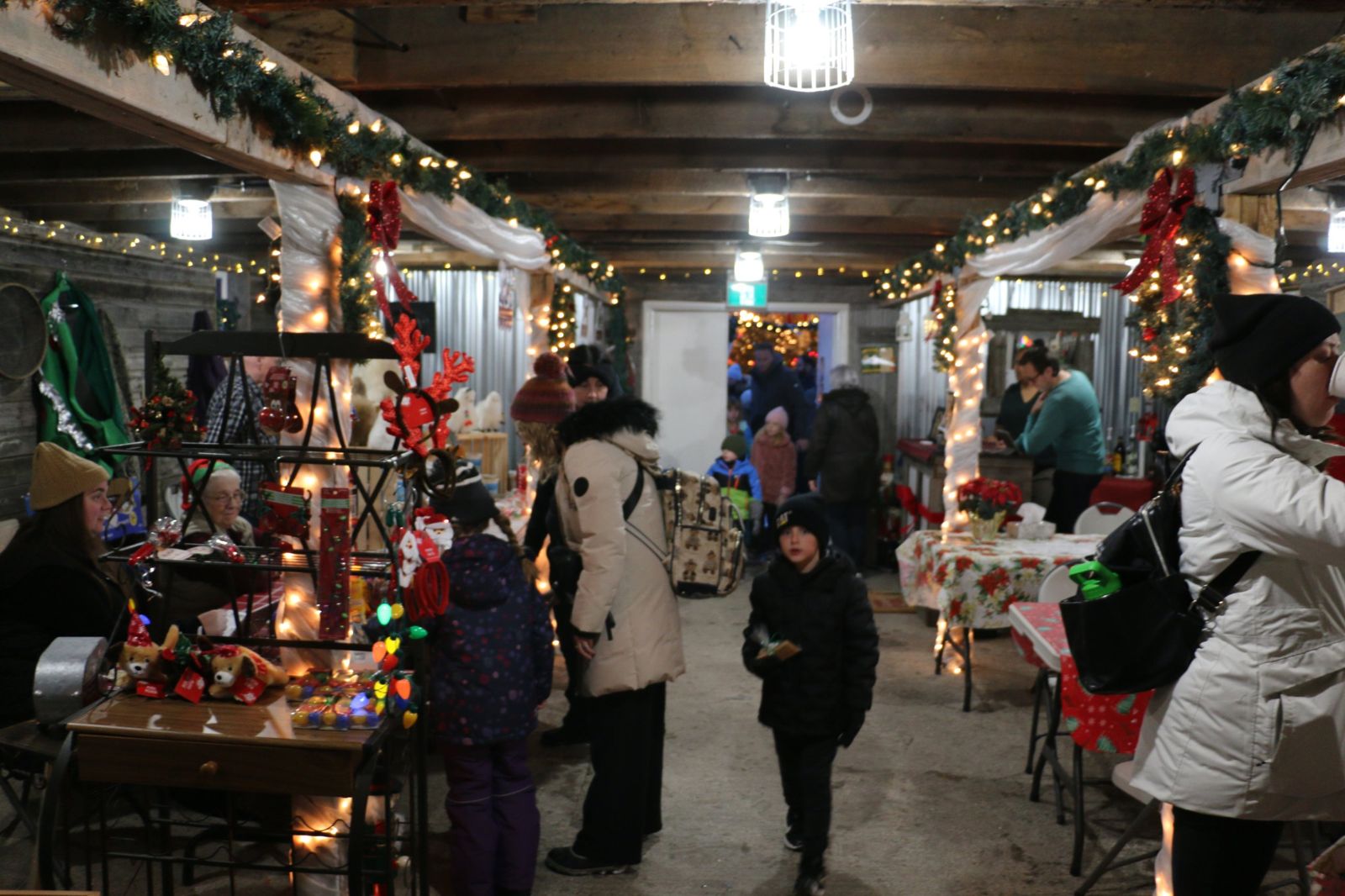 Guests browsing local vendor tables in the decorated barn